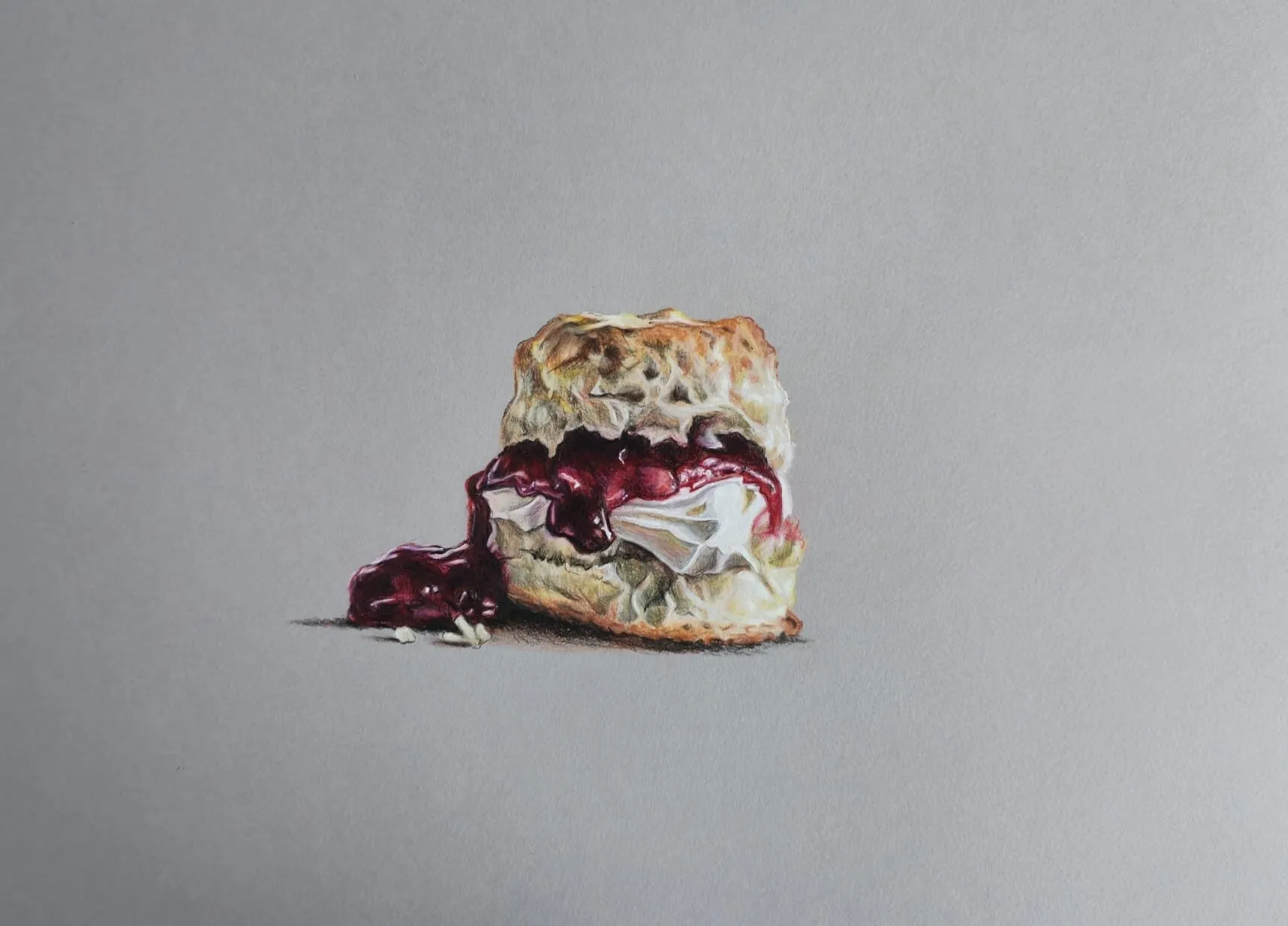 A scone with cream and jam drawn in coloured pencil on grey paper