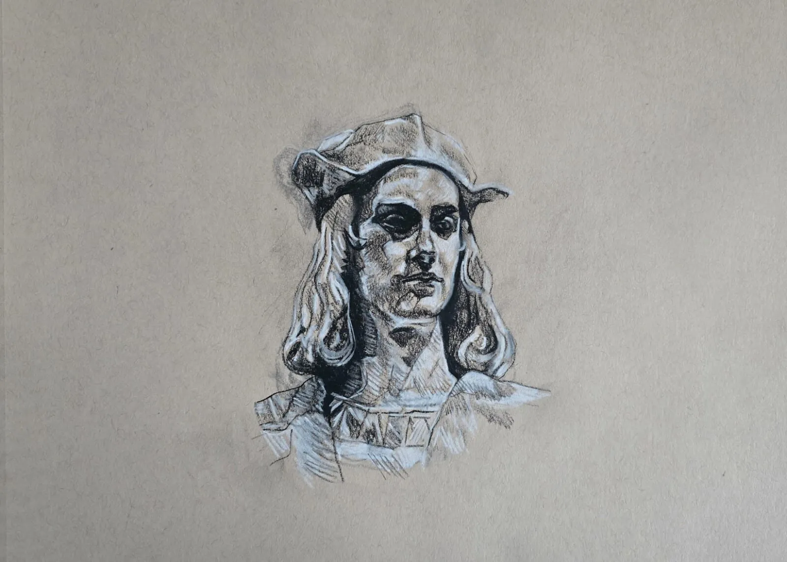 A head study of a figure in a cap in dark and white pencil on toned paper